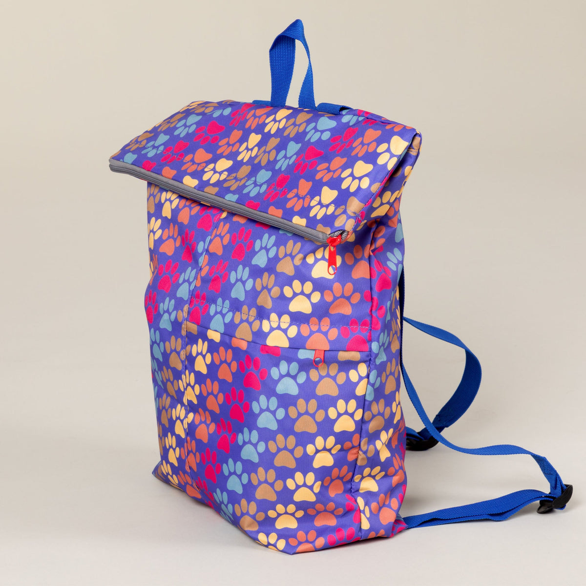 Three-quarter view of the Diagonal Paws backpack with blue shoulder straps.