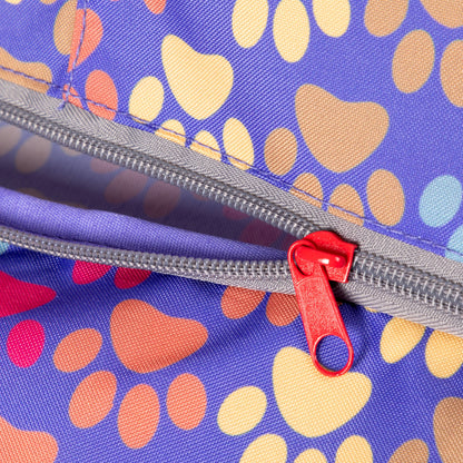 Close view of the Diagonal Paws multicolor fabric and red zipper pull.