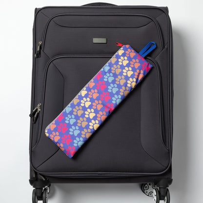 Folded Diagonal Paws backpack displayed on a rolling suitcase; suitcase not included.