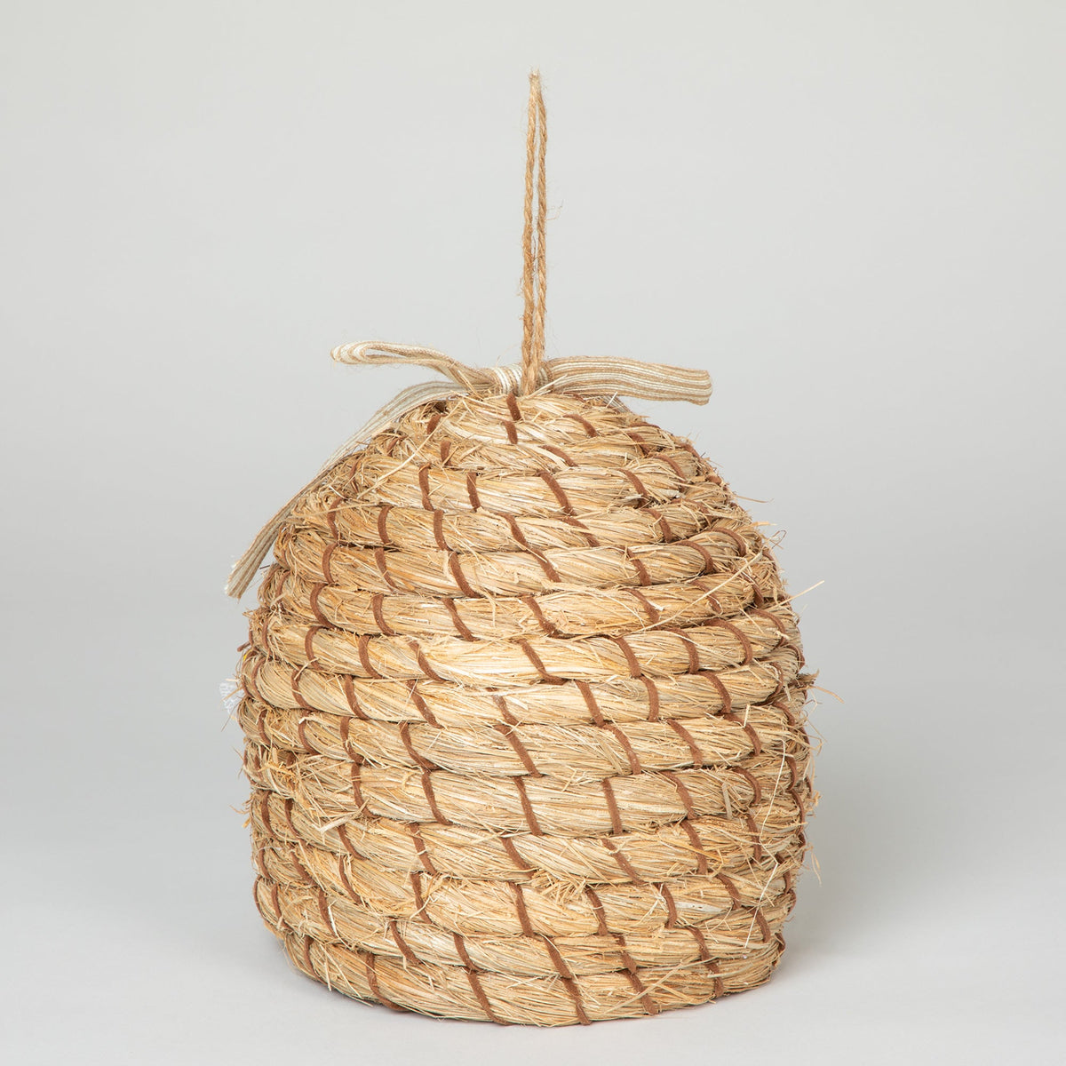 Rear view of the decorative beehive-shaped birdhouse with hanging loop.