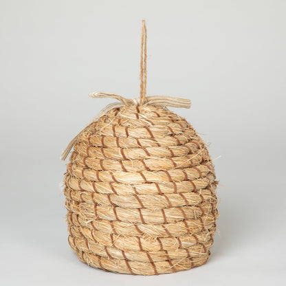 Rear view of the decorative beehive-shaped birdhouse with hanging loop.