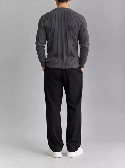 Dark gray ribbed knit top, modelled rear view. Trousers and shoes are not included.