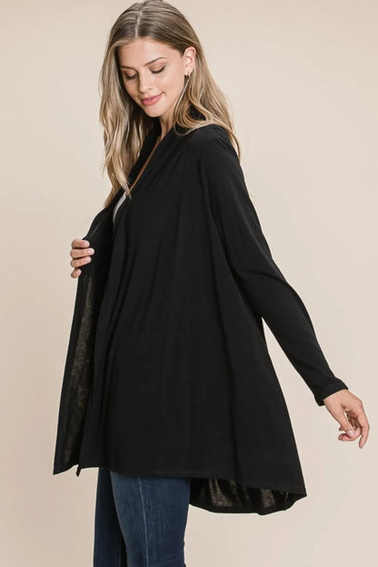 Black open-front cardigan, side view showing the draped hem