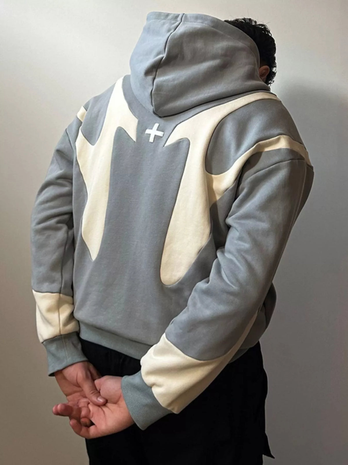 Gray and cream oversized zip hoodie worn from the back
