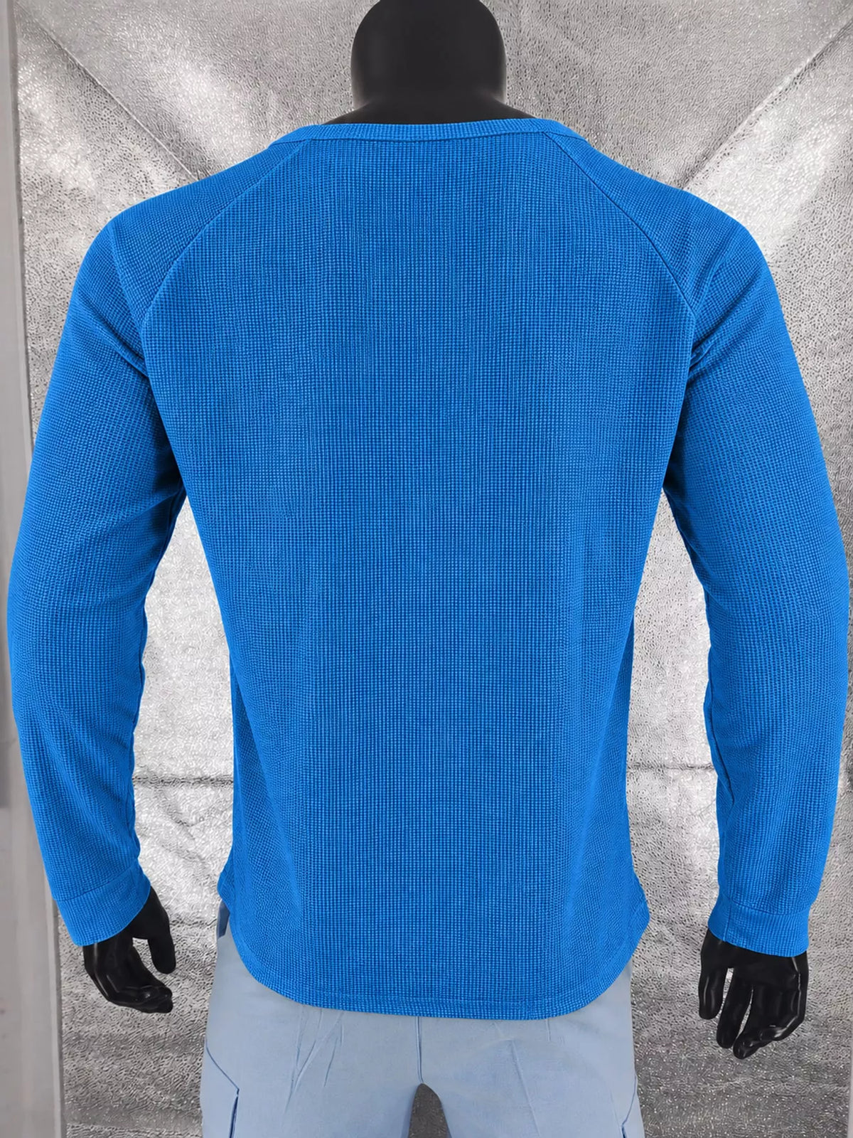 Royal blue men’s waffle-knit Henley on a mannequin, back view.