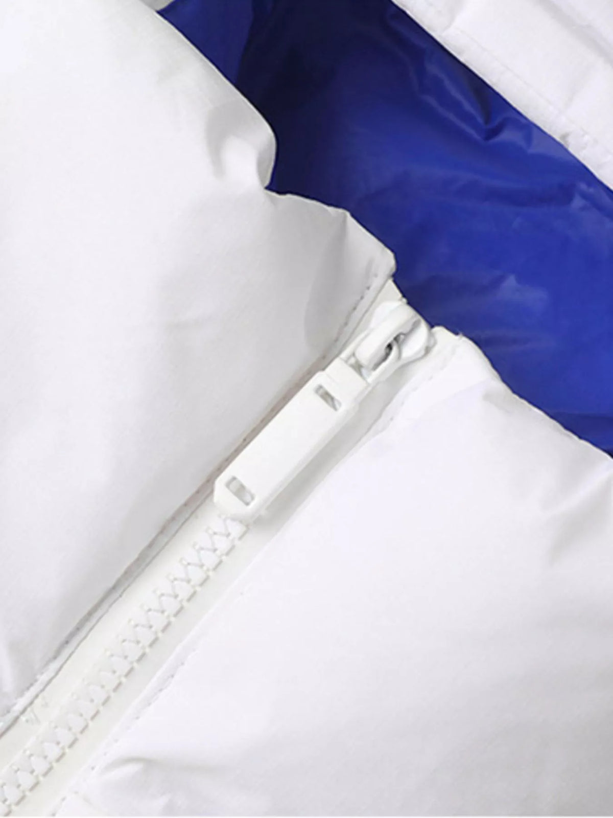 White hooded jacket front zipper beside blue contrast lining, close-up