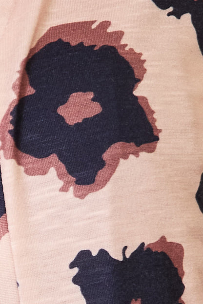 Close-up of the cardigan's pink, burgundy and black leopard-print fabric.