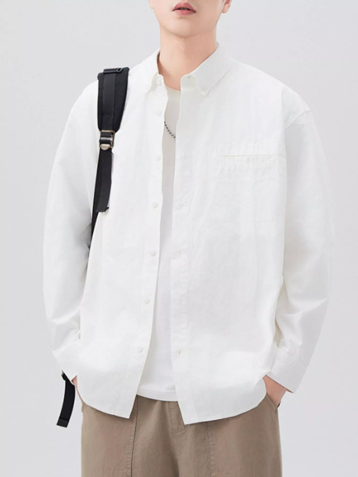 White long-sleeve shirt open over a white T-shirt, front view
