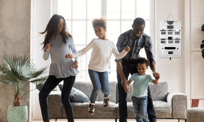 Family at home with a Bagby FAMILY organizer hanging in the room