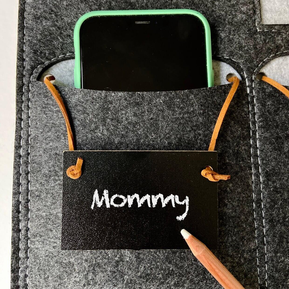 Close view of a phone in the gray and mint Bagby FAMILY pocket