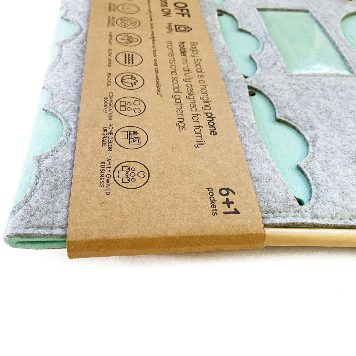 Folded gray and teal Bagby FAMILY organizer with paper sleeve