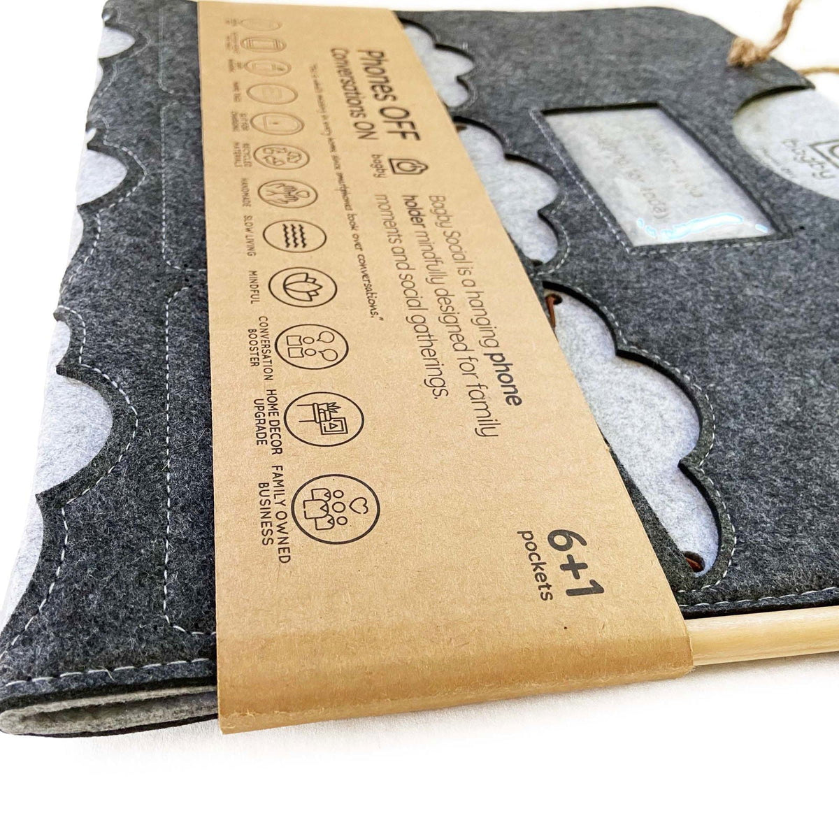 Folded charcoal and gray Bagby FAMILY organizer with paper sleeve