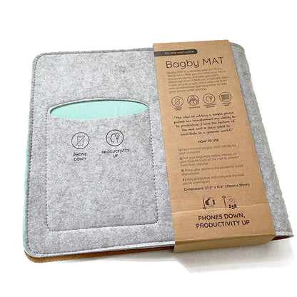 Folded Bagby MAT desk pad with its paper packaging sleeve and phone pocket