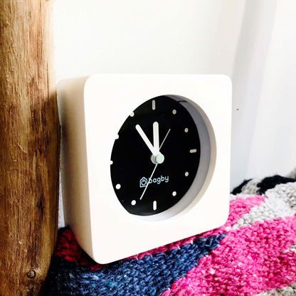 White Bagby MINIMALIST clock beside a blanket