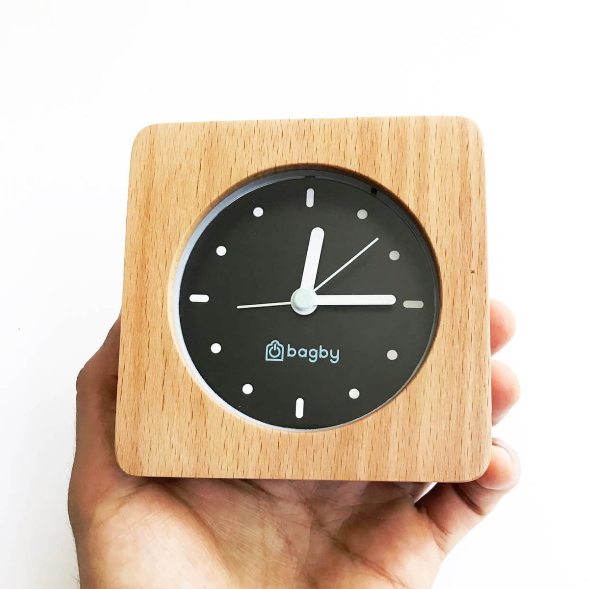 Light-wood Bagby MINIMALIST clock held in a hand