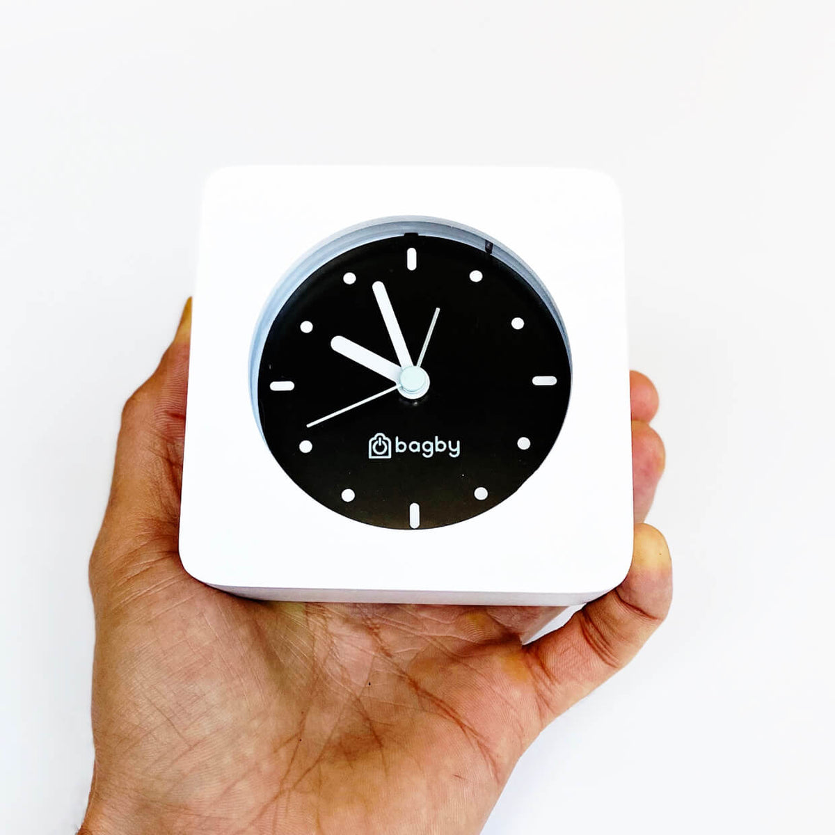 White Bagby MINIMALIST clock held in a hand