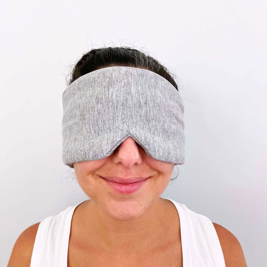 Gray Bagby NIGHT sleep mask worn over the eyes, front view