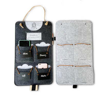 Lifestyle scene with a charcoal four-pocket phone organizer hanging on a ladder beside people socializing.