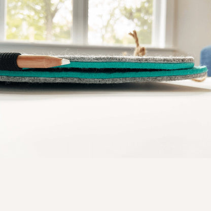 Close-up of the organizer's stitched charcoal felt edge and brown cord.