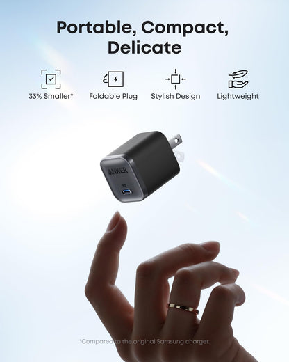 Anker Nano 45W — Black compact charger with foldable plug shown above a hand