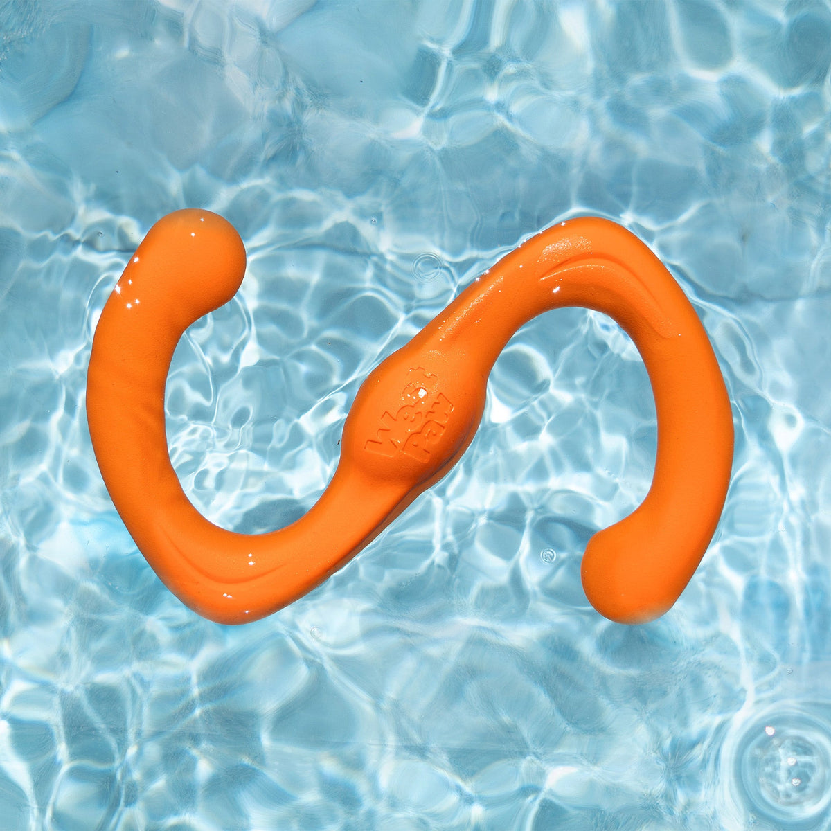 Tangerine Bumi toy floating in water.