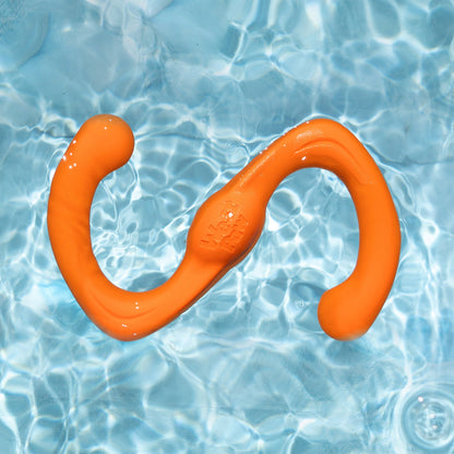 Tangerine Bumi toy floating in water.