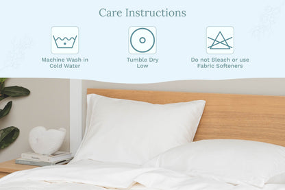 Pure White sateen pillowcases on a bed beside washing-care instructions