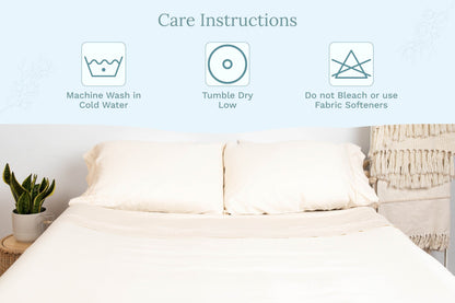 Natural Cotton sateen pillowcases on a bed beside washing-care instructions