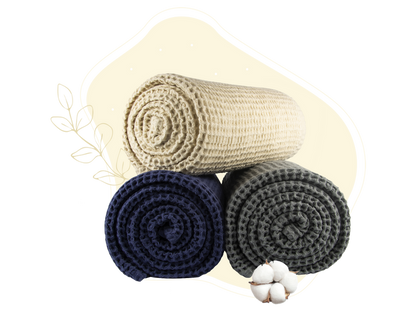 Ivory, blue and gray waffle weave throws shown rolled for color comparison