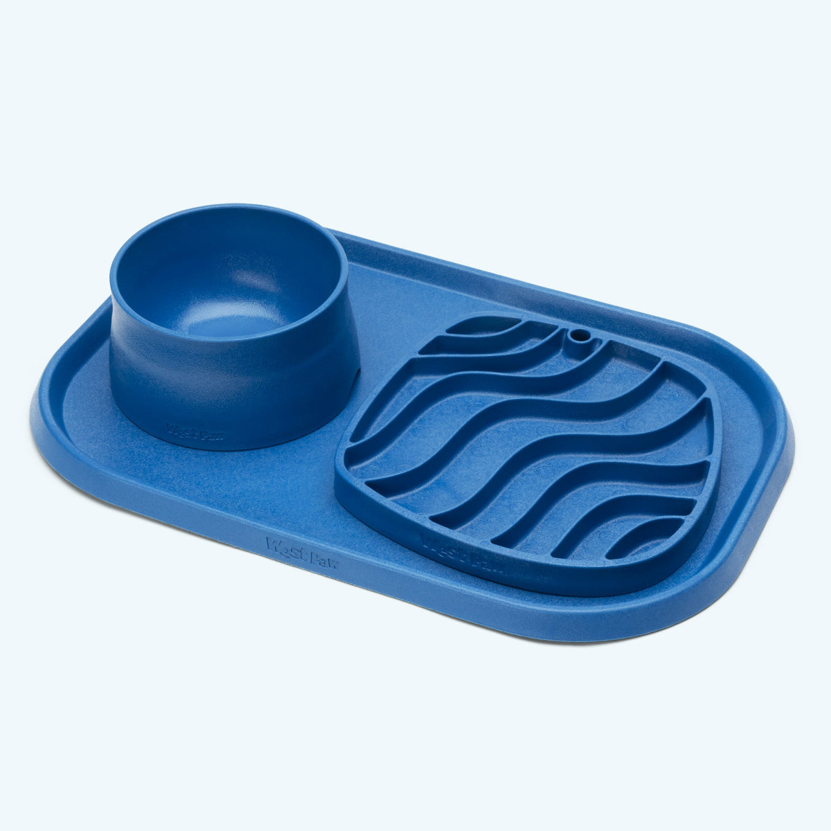Marine blue West Paw placemat with bowls and feeder accessories shown for illustration; accessories not included