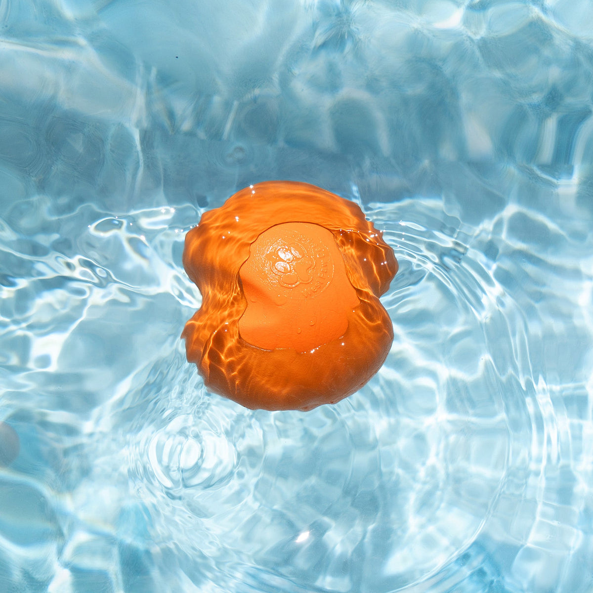 Tangerine Jive ball shown in water.