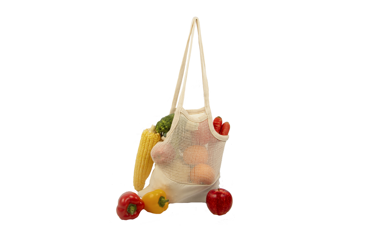 Natural cotton mesh tote with a fabric base and long handles, displayed with produce; groceries are not included.