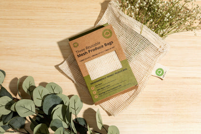 Mesh produce-bag gift box with a mesh bag on a wooden surface; decorative greenery is not included.