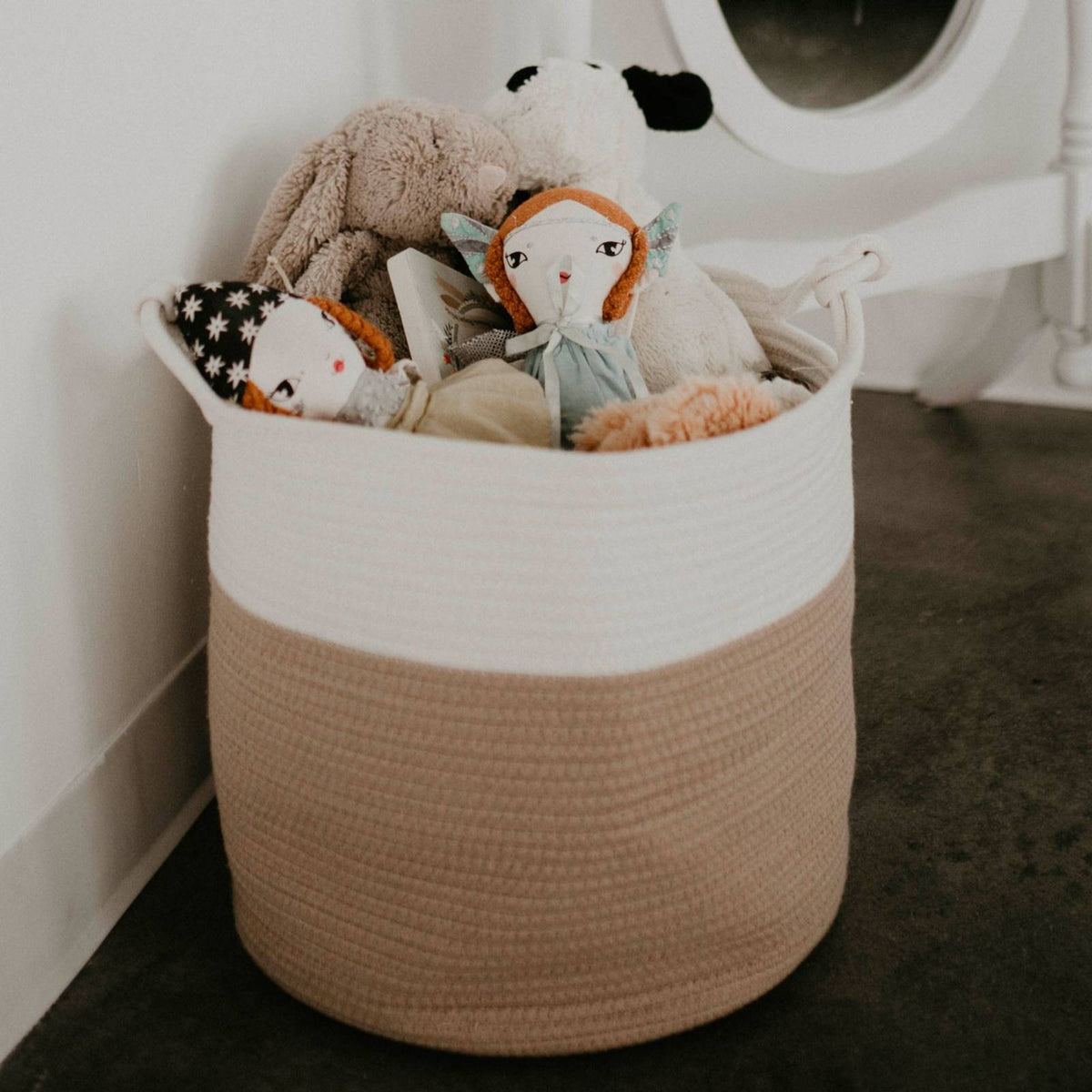 Cream and beige rope basket filled with stuffed toys; toys are not included.