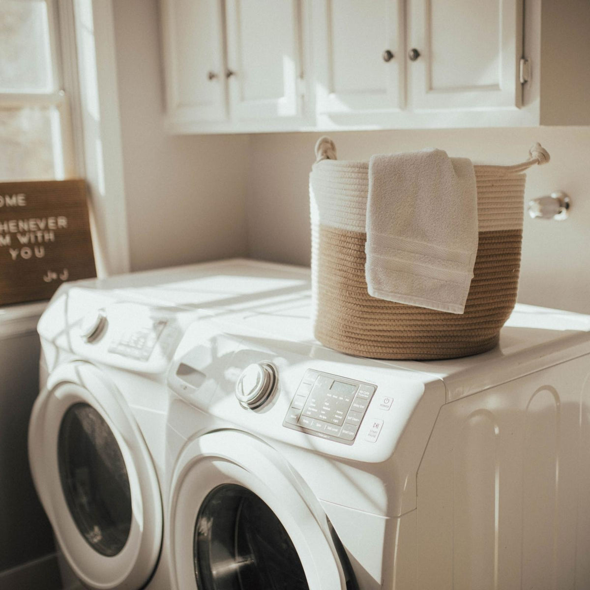 Cream and beige rope basket on a washing machine with a towel; towel and appliance are not included.