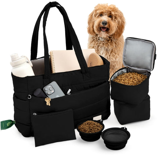 Black quilted dog travel tote, pictured beside a dog with travel items.