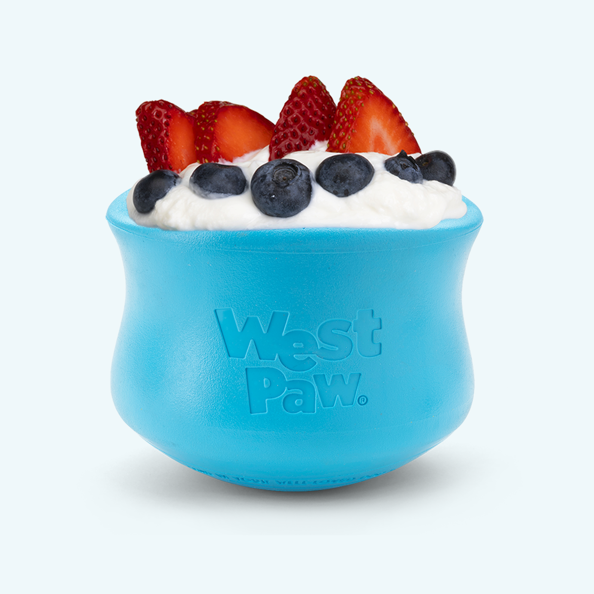 Aqua Blue West Paw Toppl toy shown filled with food and berries; food is not included.