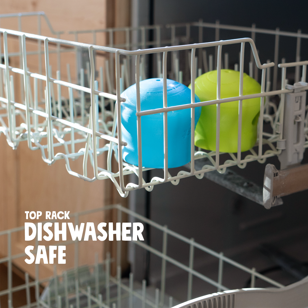 Aqua Blue and Granny Smith West Paw Toppl toys in the top rack of a dishwasher; toys shown are separate items.