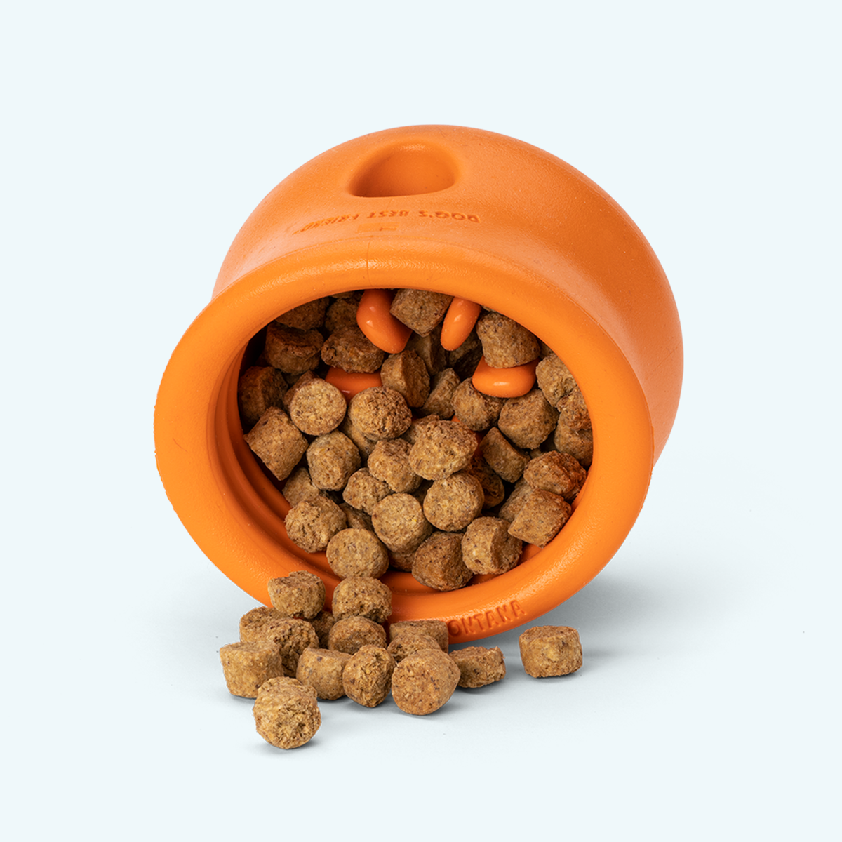 Tangerine West Paw Toppl toy shown with kibble spilling from its opening; kibble is not included.