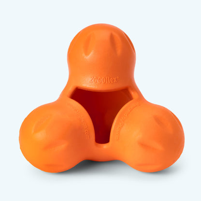 Close-up of a Tangerine West Paw Tux treat toy showing its three-lobed body, shallow cavity and embossed Zogoflex mark.
