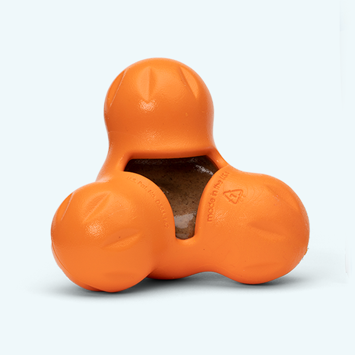 Tangerine West Paw Tux treat toy shown from the front with its central treat cavity visible.