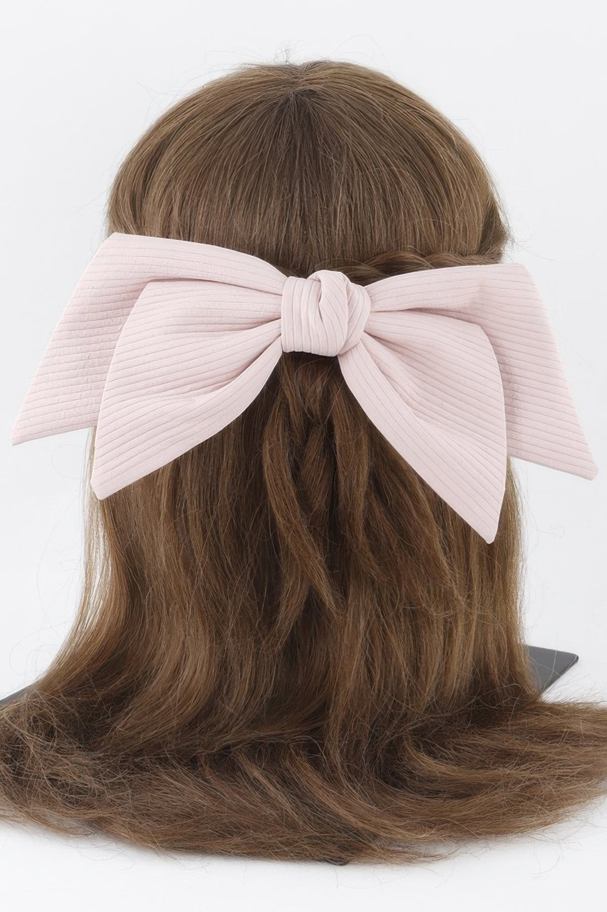 Pink lined ribbon hair clip shown from the back in hair