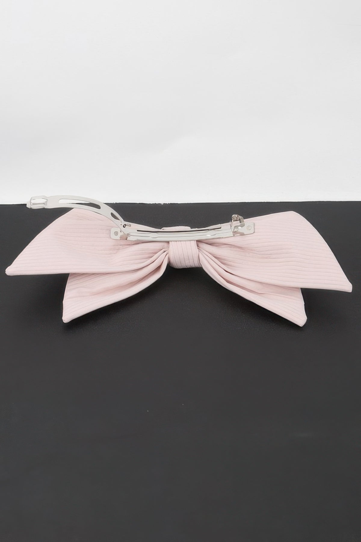 Back of pink ribbon hair clip showing the fastening clip