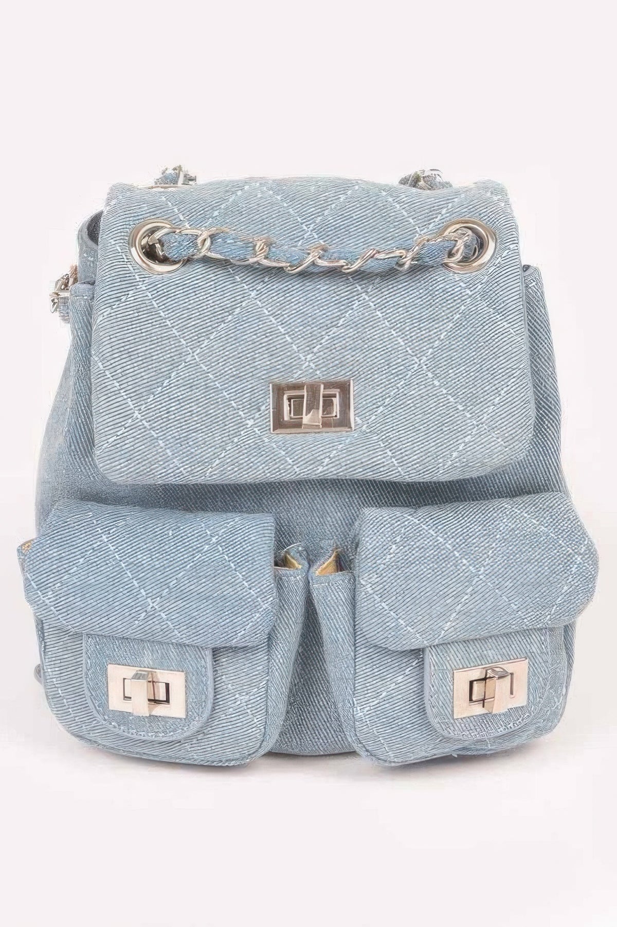Light-blue quilted denim backpack with double front pockets and metal-tone accents