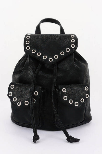 Black faux-leather backpack, front view with curved flap, metal eyelets and two front pockets.