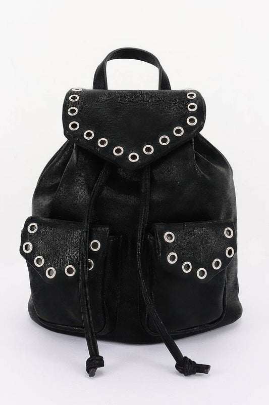 Black faux-leather backpack, front view with curved flap, metal eyelets and two front pockets.