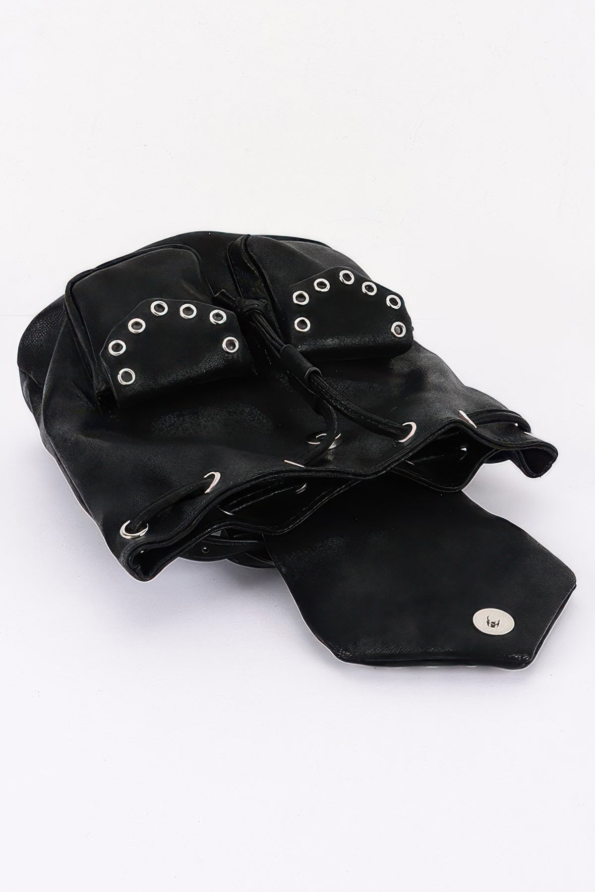Black faux-leather backpack lying open to show the curved flap and drawstring opening.