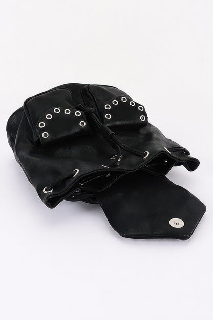Black faux-leather backpack lying open to show the curved flap and drawstring opening.