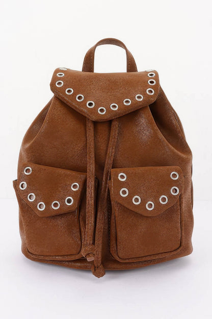 Camel faux-leather backpack, front view with curved flap, metal eyelets and two front pockets.