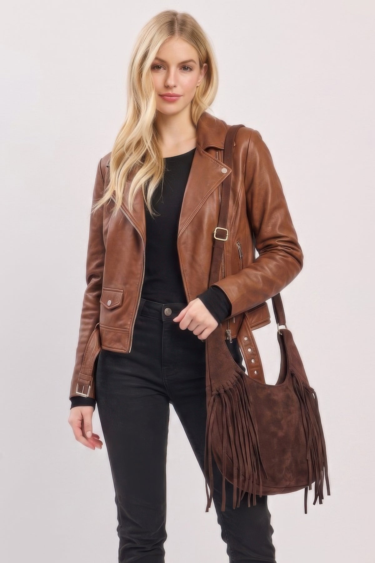 Model carrying the Espresso faux suede fringe hobo bag with adjustable strap